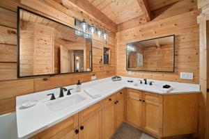 a bathroom with a sink and two mirrors at Freedom Lodge in Blowing Rock +38 photos