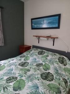 a bedroom with a bed with a green and white comforter at Boszicht in Elim