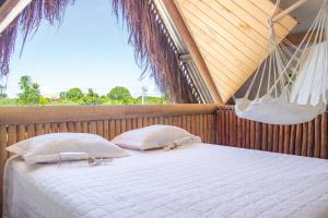 a bed in a hammock with two pillows at Cabana Serena in Corumbau +67 photos