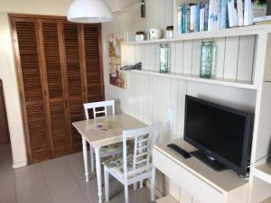 a living room with a television and a table with chairs at Апартаменты 303 - Studio in Funchal