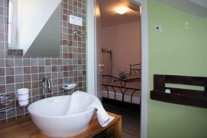 a bathroom with a bath tub and a sink at Mountain Stone Villa with pool in Stanići +22 photos