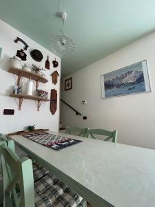 a dining room table with chairs and a counter top at Casa Lucrezia - Valbruna in Valbruna