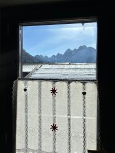 a window with a view of a mountain at Casa Lucrezia - Valbruna in Valbruna +25 photos