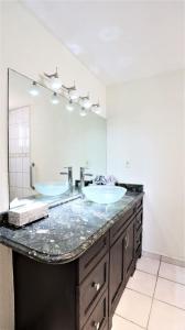 a bathroom with two sinks and a large mirror at Tijuana Beach View & Patio in Tijuana