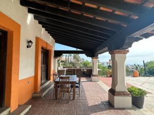 a patio with a table and chairs under a roof at Tijuana Beach View & Patio in Tijuana