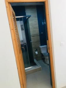 a bathroom with a glass shower and a toilet at Sweet Spot Palmarejo in Praia +15 photos