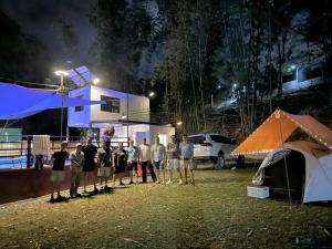 a group of people standing in front of a basketball hoop at night at Kawayan Farmstead in Antipolo