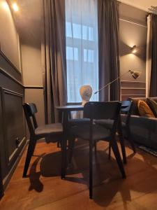 a table and chairs in a room with a bed at Hej Bydgoszcz - Apartament LUX przy Starym Rynku in Bydgoszcz