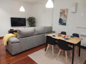 a living room with a couch and a table at Nuevo, junto al Ayuntamiento y Casco Viejo in Bilbao