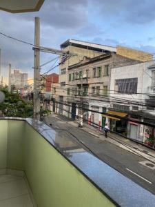 a view of a city street from a balcony at Hotel Amanhecer -650M DA FERINHA DA MADRUGADA ,1,3 KM DA 25 DE MARÇO, 550M DO MERCADÃO MUNICIPAL ,1,1 KM DA ESTAÇÃO DA LUZ in São Paulo