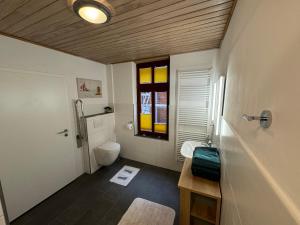 a bathroom with a toilet and a window at Haus Wagenknecht in Borkum +26 photos