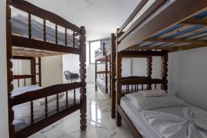 a bedroom with three bunk beds and a desk at Cobertura a beira mar com piscina e churrasqueira in Praia Grande +33 photos