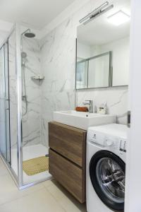 a bathroom with a washing machine and a washer at Villa Mária Marta in Mirce +27 photos