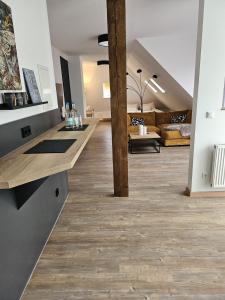 una gran sala de estar con suelo de madera y vigas. en Pro Home Mara, en Bad Oeynhausen