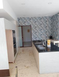 a kitchen with a sink and a counter top at Casa acogedora in Chetumal
