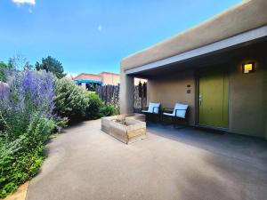 a patio with two chairs and a firepit in front of a building at Casa Saint Francis- King Bed-Patio & Fire Pit -2BR in Santa Fe