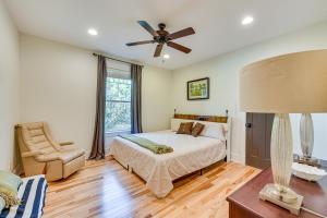 a bedroom with a bed and a ceiling fan at Fire Pit and Patio Spacious Southern Pines Retreat in Southern Pines +36 photos