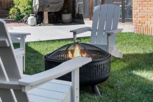 a fire pit sitting next to a chair and a grill at Elegant 3BR Oasis in Dundee Close to Downtown in Omaha