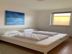 two beds in a white room with a window at Ferienhaus Seeadler am Vilzsee in Mirow in Mirow