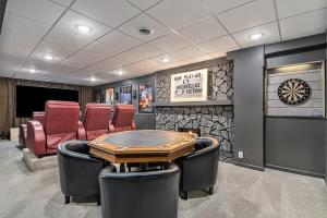 a room with chairs and a table and a dartboard at Luxury Designer Home Theatre Games & BBQ Grill in Millard