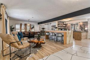 a living room and kitchen with a couch and a table at Luxury Designer Home Theatre Games & BBQ Grill in Millard