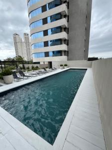 a swimming pool in front of a building at Brickell Pileta 2A Bross in Tigre