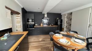 a kitchen with two wooden tables in a room at Gîte "Le Saint Antoine"parking privé in Autun