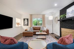 a living room with a couch and a fireplace at Cozy & Elegant Gem Fenced Yard BBQ & Games in Omaha