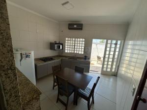 a kitchen with a table and chairs and a refrigerator at Network Inn Privativo in Campinas