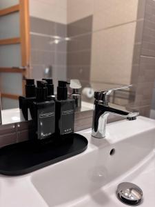 a bathroom sink with a faucet and a mirror at Alsóerdő Villa Resort in Zalaegerszeg +27 photos