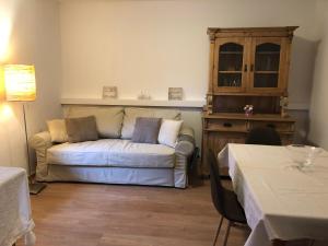 a living room with a couch and a table at Apartment Maximilian in Völs am Schlern