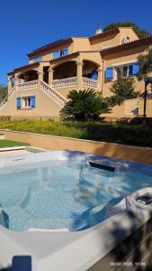 a large swimming pool in front of a house at La Maison Bleue in Toulon