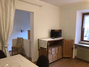 a living room with a tv on a dresser with a television at Apartment Maximilian in Völs am Schlern