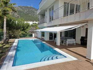a swimming pool in front of a house at Villa -Heated pool -Amazing view -Ideal for groups in Mijas