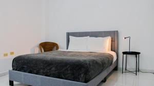 a bedroom with a large bed with white pillows at Arecibo Hotel 2104 in Arecibo