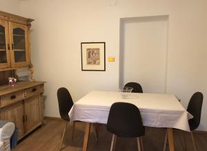 a dining room with a table with chairs and a cabinet at Apartment Maximilian in Völs am Schlern +9 photos