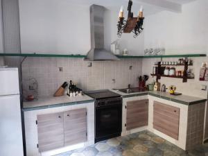 a kitchen with a stove and a sink at Casa della Scalinata in Maccagno Superiore +10 photos