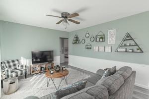 a living room with a couch and a tv at The Ranch on RaceStreet in Marion