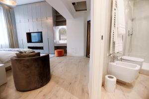 a bedroom with a bed and a bathroom with a toilet at Duomo Florence - Esclusive Luxury in Florence +81 photos
