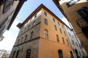 a yellow building in the middle of a street at Duomo Florence - Esclusive Luxury in Florence
