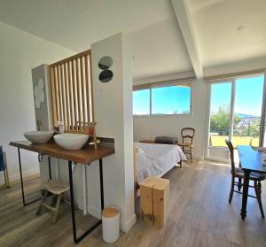 a room with two sinks and a bedroom with a bed at La Maison Bleue in Toulon