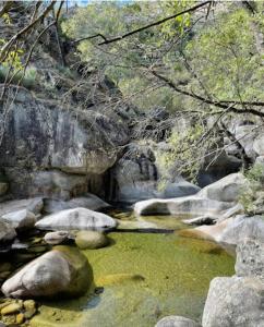 a pool of water with rocks in a river at Piscinas, Serra da Estrela AL in Bouça