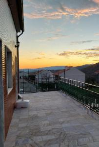 a balcony with a sunset in the background at Piscinas, Serra da Estrela AL in Bouça