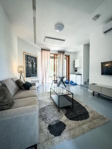 a living room with a couch and a table at Oasis Airport Apartments and Rooms in Velika Gorica