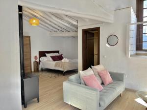 a living room with a couch and a bed at Casa Salome, Alojamiento con terraza y vistas al valle in Benadalid