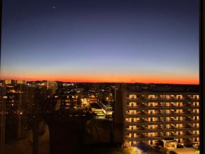 a view of a city at sunset from a building at Koselig leilighet in Stavanger