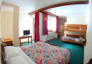 Postel nebo postele na pokoji v ubytování Hotel Canin
