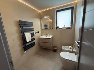 a bathroom with a sink and a toilet and a mirror at A Volte nel Salento-Porta Napoli in Lecce