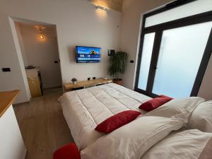 a bedroom with a large bed with red pillows on it at A Volte nel Salento-Porta Napoli in Lecce +19 photos