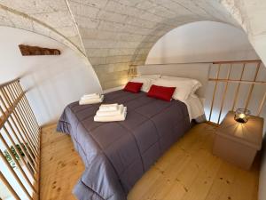 a bedroom with a bed with two towels on it at A Volte nel Salento-Porta Napoli in Lecce